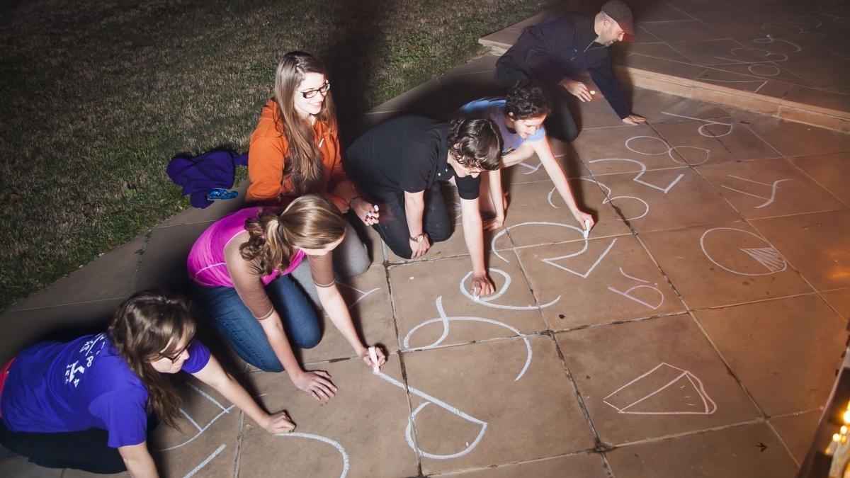 Trinity Math Students draw the numerals of Pi on a campus sidewalk